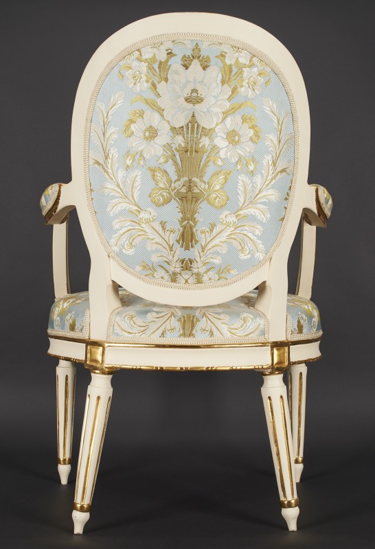 Armchair with medallion-shaped armrests