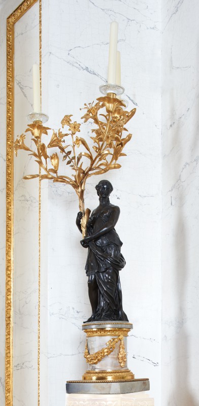 Candelabra in the form of woman holding bouquets of lilies and hyacinths