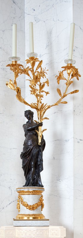 Candelabra in the form of woman holding bouquets of lilies and hyacinths