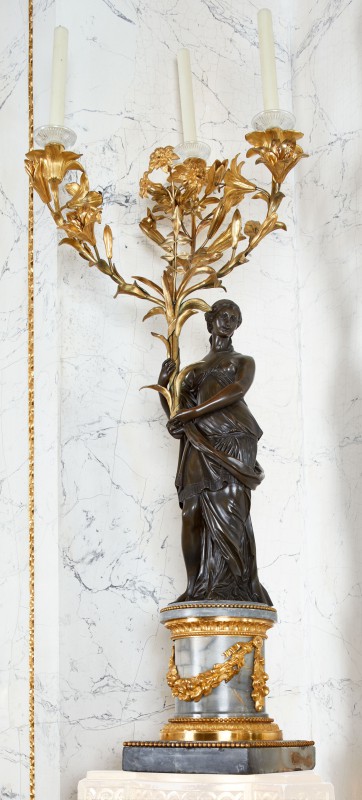 Candelabra in the form of woman holding bouquets of lilies and hyacinths