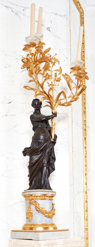 Candelabra in the form of woman holding bouquets of lilies and hyacinths