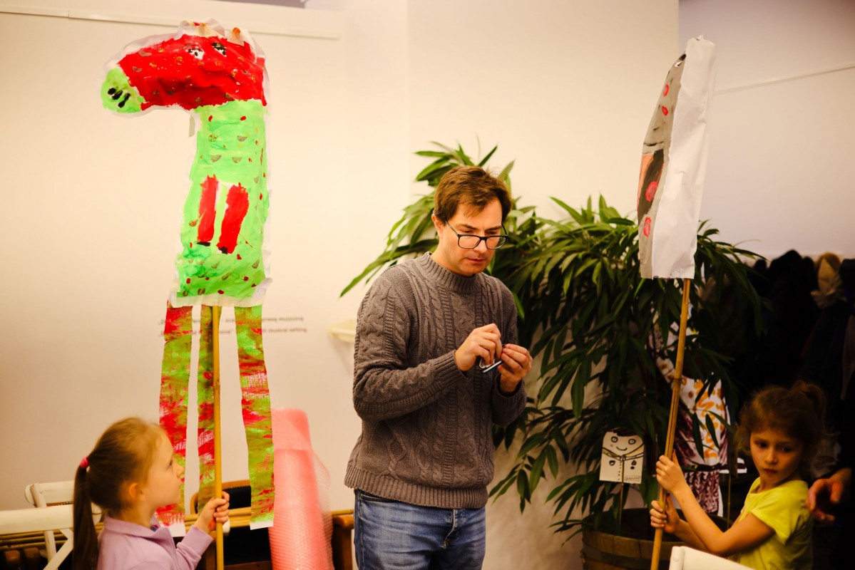 Dzieci i mężczyzna w pomieszczeniu.