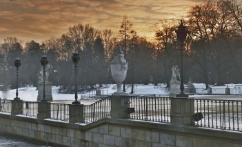 Taras Pałacu na Wyspie zimą, widoczne są latarnie, rzeźby i drzewa.