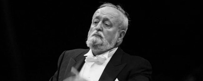 Krzysztof Penderecki na czarno-białym zdjęciu, w smokingu. 