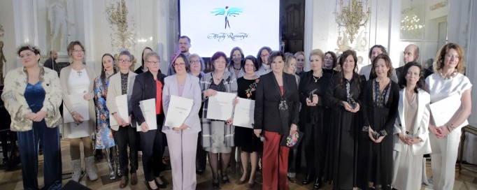 Duża grupa ludzi pozuje do zdjęcia w Sali Balowej. 