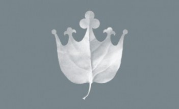 Logo Łazienek Królewskich przedstawiające liść zakończony na kształ korony.